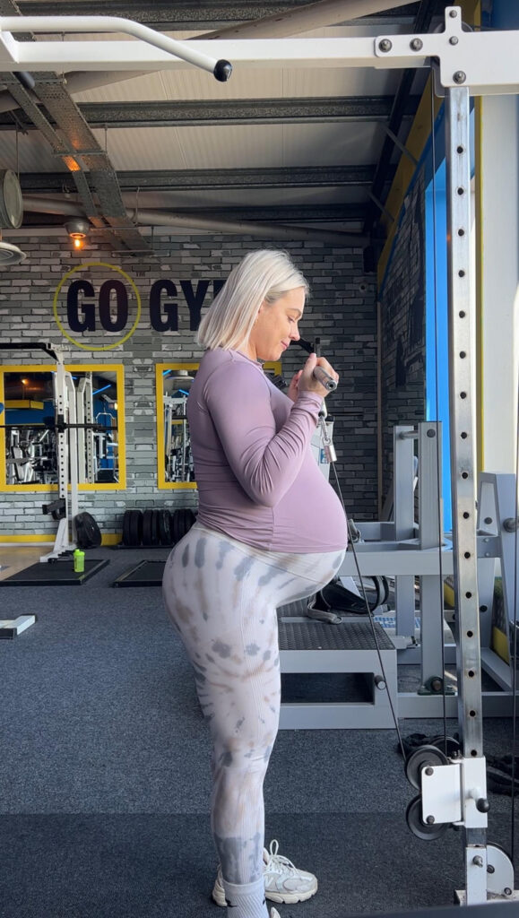 A pregnant bodybuilder defends her decision to continue exercising, citing health benefits and previous successful pregnancies. Despite criticism, she plans to resume her routine after giving birth.