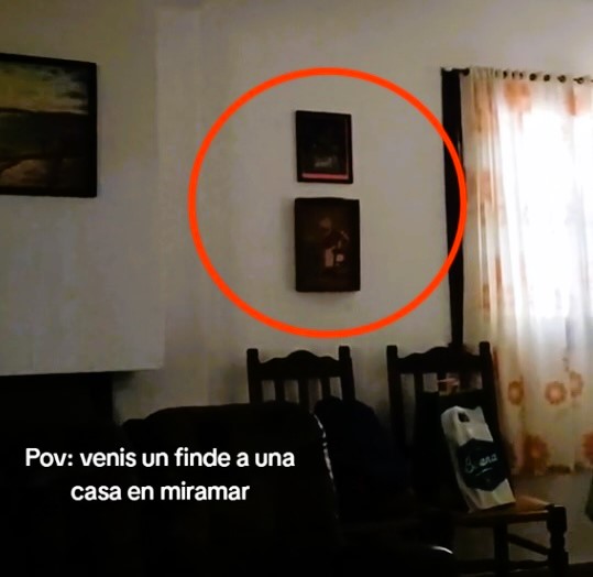 A group of friends on a weekend getaway captured chilling footage of a "ghostly" encounter as a painting inexplicably moves on its own.