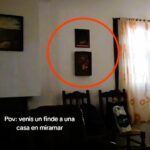 A group of friends on a weekend getaway captured chilling footage of a "ghostly" encounter as a painting inexplicably moves on its own.