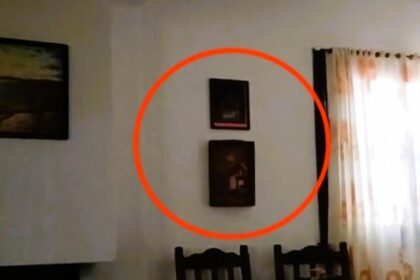 A group of friends on a weekend getaway captured chilling footage of a "ghostly" encounter as a painting inexplicably moves on its own.