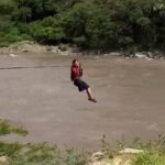 Schoolchildren in northern Colombia brave an alligator-infested river daily, using a terrifying zipline to reach class. Despite promises for a new bridge, they rely on this perilous system.