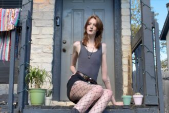 Maci Currin, with record-breaking legs, embraces uniqueness despite trolls' comparisons to Slenderman. Standing at 6'10", she's empowering tall women worldwide.