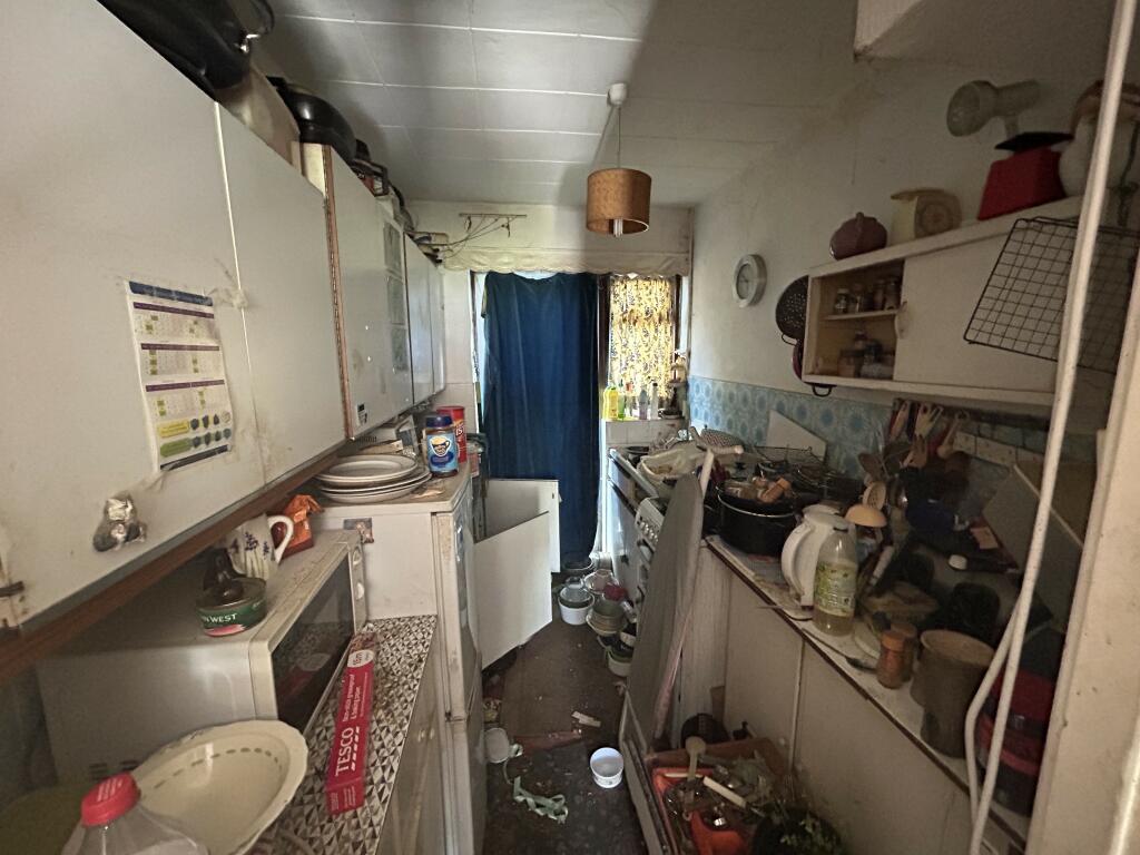 A cluttered three-bedroom house in Isleworth, London, filled with possessions, hits the market for £175,000, attracting interest despite the need for renovation.