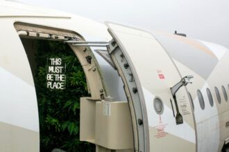 Experience luxury in a former Etihad airplane converted into a unique staycation spot in Tenby, West Wales. Fuselage bedrooms, cockpit-style kitchen, and outdoor seating await.