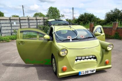 A custom-built replica of Professor Z from Cars 2, made from a 2009 Toyota IQ, is for sale at £7,000. The unique car features the character’s iconic monocle, eyes, and mouth.
