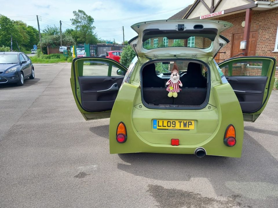 A custom-built replica of Professor Z from Cars 2, made from a 2009 Toyota IQ, is for sale at £7,000. The unique car features the character’s iconic monocle, eyes, and mouth.