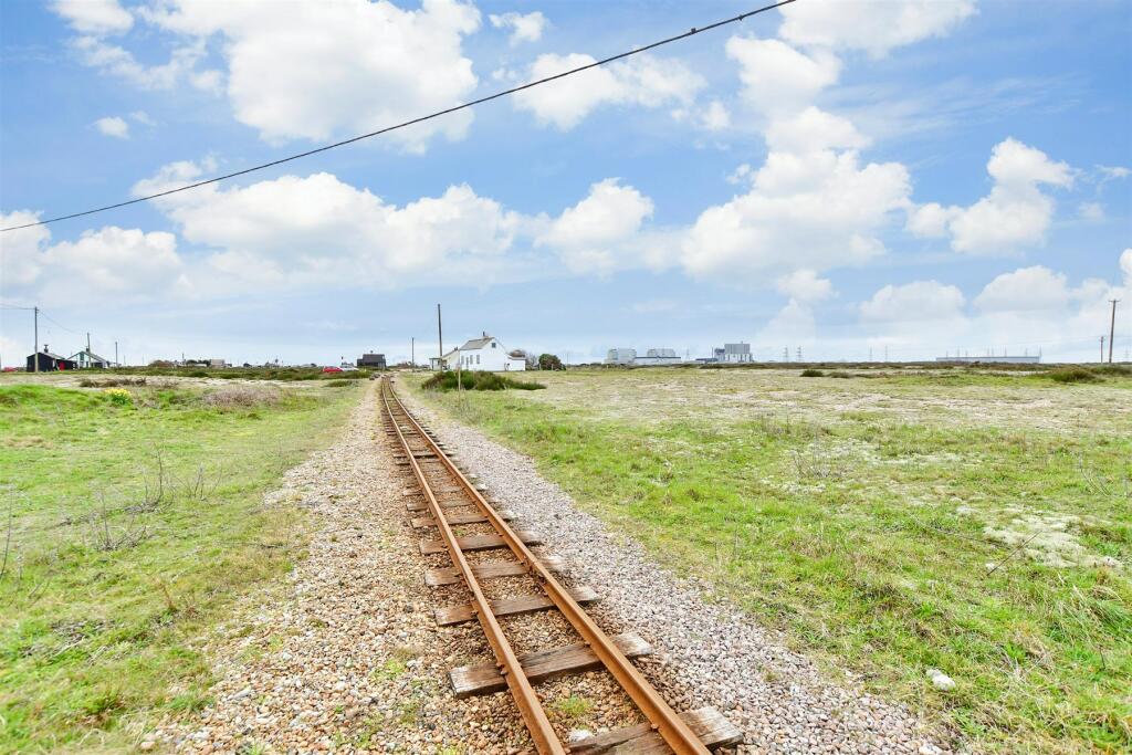 Own a detached bungalow in Britain's only desert, Dungeness, with stunning views and quirky charm. Experience isolation and atmosphere for £875k.