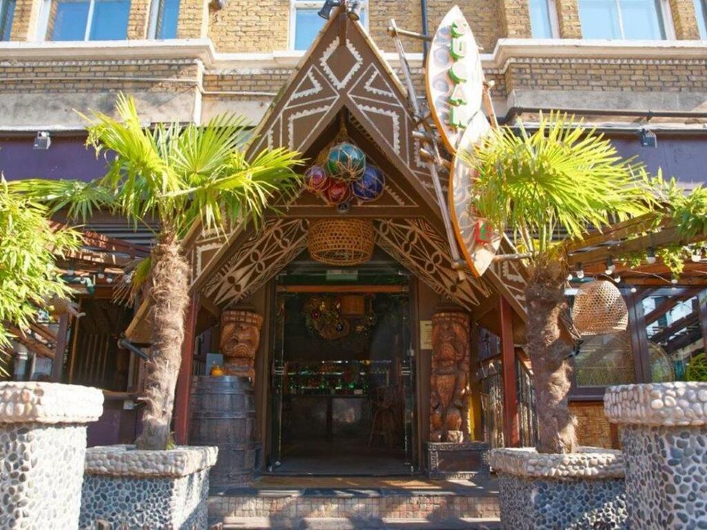 The Sugar Cane Bar, a Tiki-themed nightclub in Clapham, south London, is for sale for £100,000. Established in 2007, it features a bamboo bar, Tiki hut booths, unique cocktails, and share platters, with a 2am weekend license and two floors for the new owner to utilize.