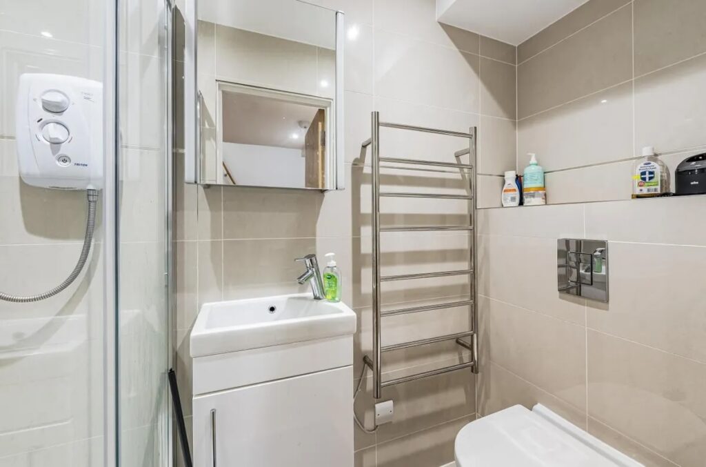 Tiny London flat slightly bigger than a football six-yard box rents for £1,395/month. The 222 sq ft studio features a raised bed over the sofa and modern kitchenette.