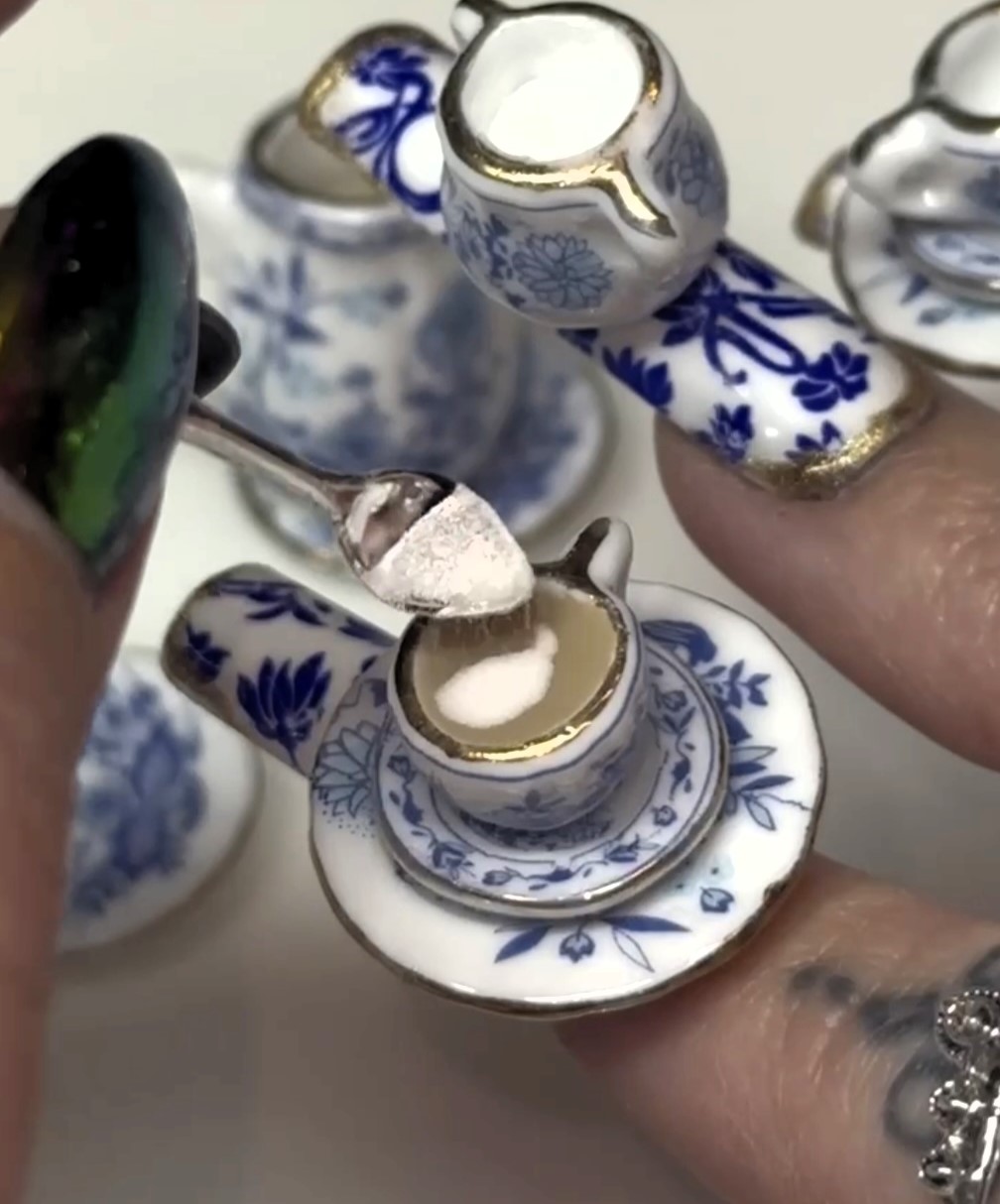 Social media users are stunned by a woman's bizarre manicure that doubles as a tea-brewing set. The unique creation, crafted by nail technician Morgan Gilbertson, has garnered massive attention, sparking both awe and confusion online.