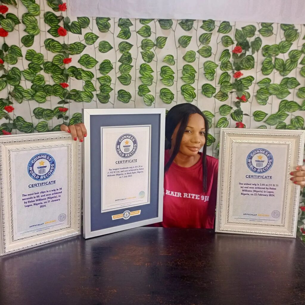 Helen Williams sets a Guinness World Record with an 11 ft 11 in wide wig, crafted from 800 bundles of hair and over 1,000 rhinestones, completed in just over a month.