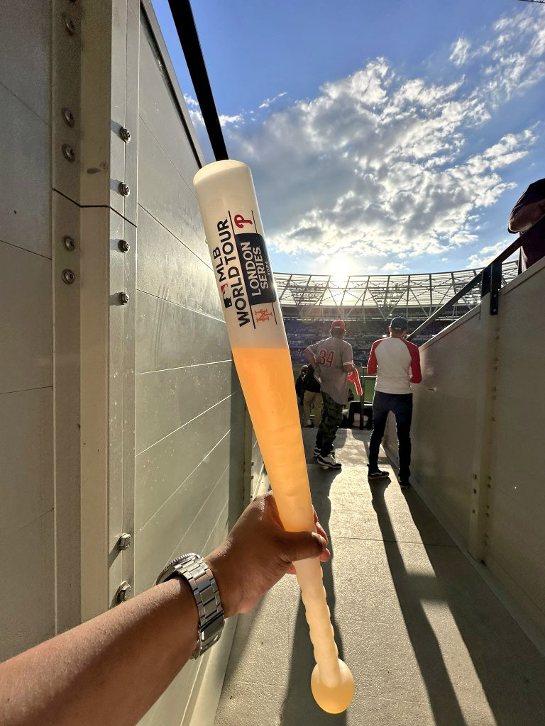 Fans are outraged by the £28.50 cost of a two-pint baseball bat drink at West Ham’s stadium during the MLB World Tour, despite enjoying the Phillies vs. Mets game.