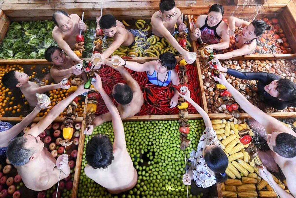 A hotel in Hangzhou, China, offers a unique spa experience where guests stew in a human hot pot with vegetables like chillis, lemons, corn, and apples. This peculiar spa aims to promote a healthy lifestyle and costs around £21 to £28.