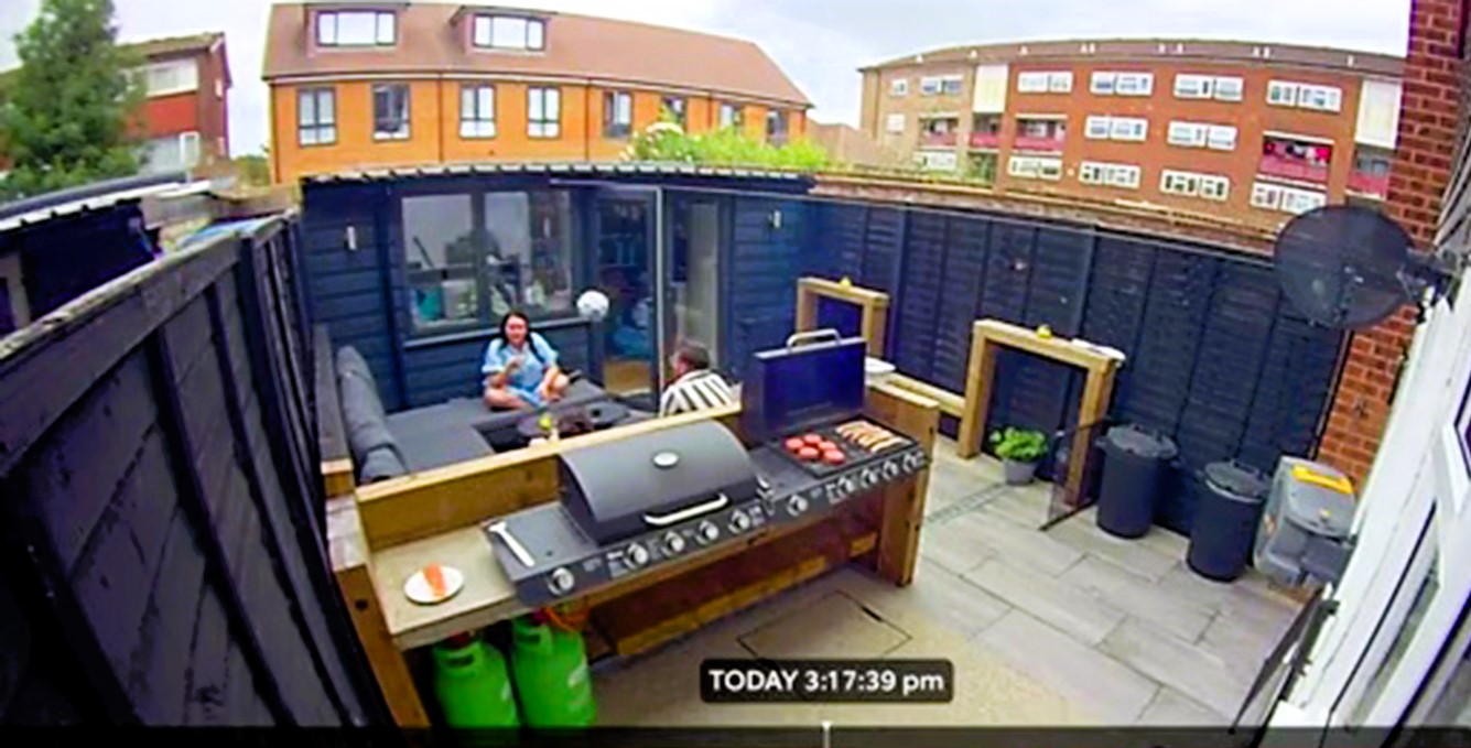 Watch the hilarious moment a football hits three people in a garden during a heatwave. Amber Rees and family left in stitches by security camera footage. Pure talent!