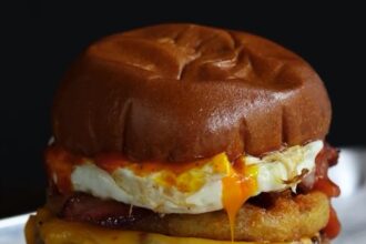 Gordon Ramsay faces backlash for his new £9 breakfast burger with a runny fried egg at Street Burger restaurants. Some love it, others call it "disgusting." Try it yourself!