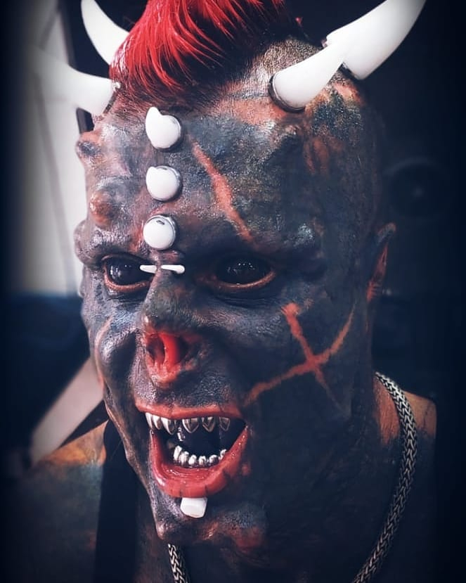 Body modification enthusiast Michel Faro do Prado, known as "Human Satan," receives a new passport with his Satanic name and altered image, showcasing his extreme transformations.
