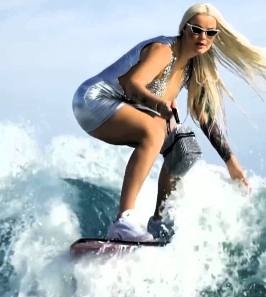 TikTok star Karolina Agata Sankiewicz ridiculed for surfing in stilettos and dresses, but her viral videos prove it's real. Watch the 'Barbie Dubai Surfer' ride the waves in style!