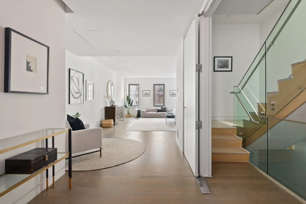 A stunning New York townhouse on the Upper East Side is listed for just under $18 million. This five-story home features a private elevator, a 23-foot indoor waterfall, six bedrooms, six bathrooms, and a rooftop garden.