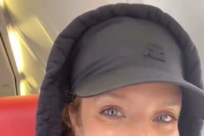 Pop star Jess Glynne flies with Jet2 for the first time, despite her hit song "Hold My Hand" being used by the airline. Fans celebrate the moment on social media.