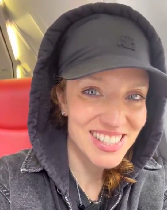 Pop star Jess Glynne flies with Jet2 for the first time, despite her hit song "Hold My Hand" being used by the airline. Fans celebrate the moment on social media.