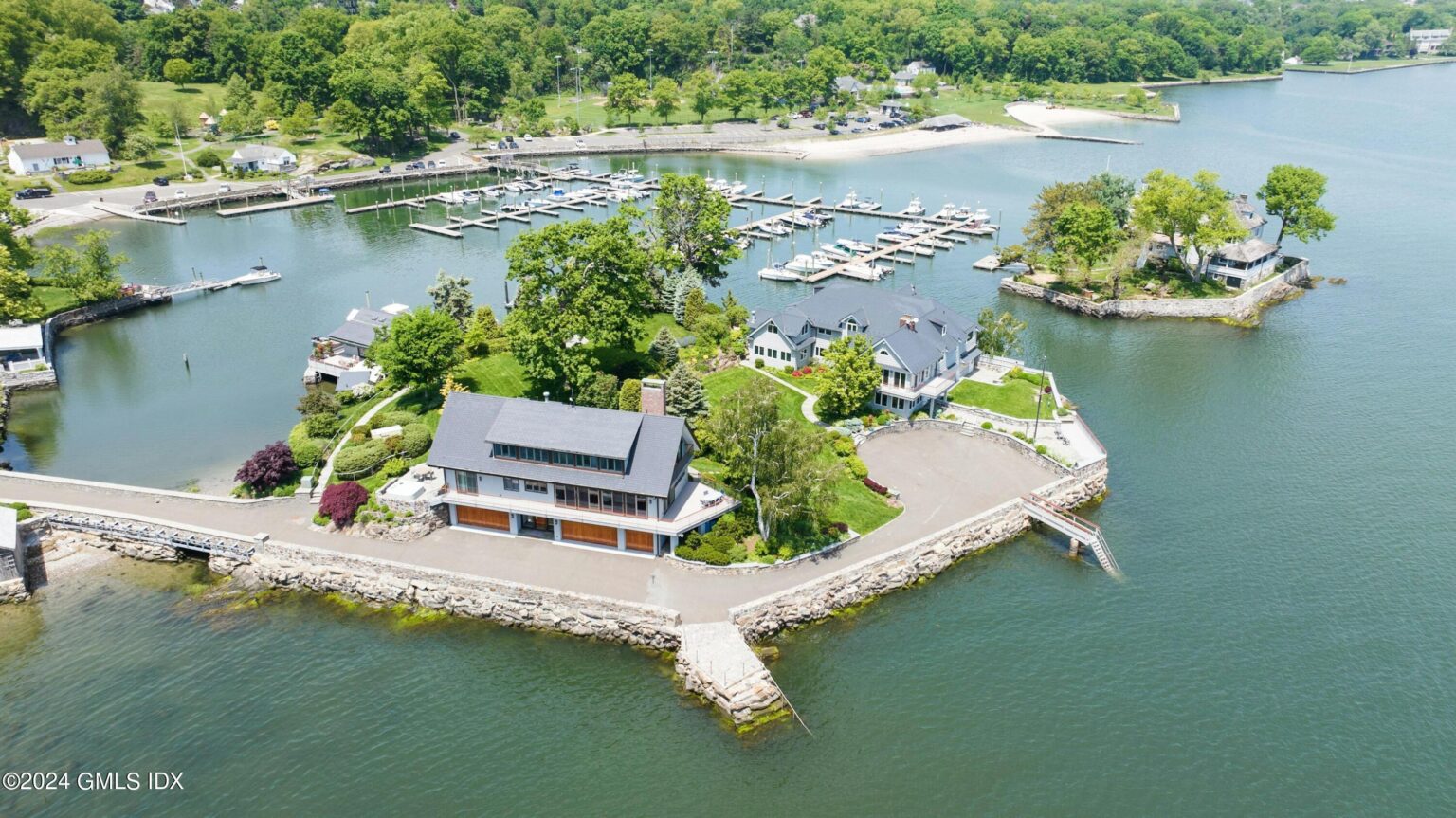 A luxurious private island home in Greenwich, Connecticut, is on the market for £19.6m ($25m). The 7-bedroom mansion sits on 1.1 acres, featuring a guesthouse, private beach, and dock.