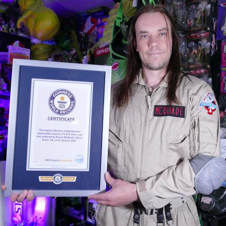 Darren McQuade, a Ghostbusters superfan, holds a world record with his collection of 2,012 memorabilia items, worth £100,000, featuring rare and unique pieces from the franchise.
