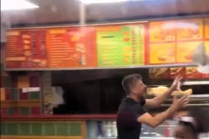 A seagull caused chaos in a Swansea fried chicken shop, flying around customers until a man in khaki shorts calmly caught it and released it outside, amusing onlookers.
