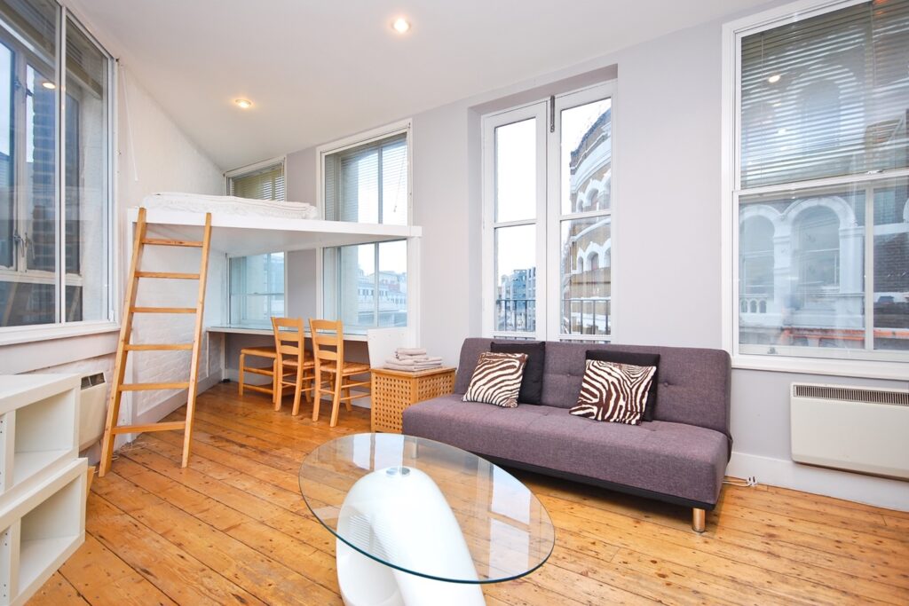 A WFH studio flat in Farringdon, East London, features a unique triangle-shaped bed for £1,500/month. Includes kitchenette, workspace, and bathroom. No pets, garden, or parking.