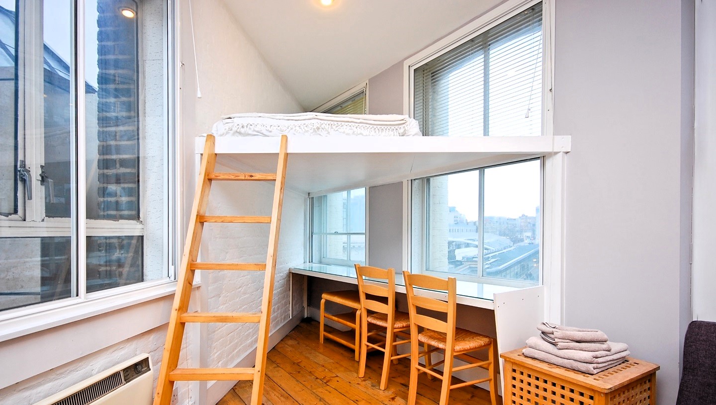 A WFH studio flat in Farringdon, East London, features a unique triangle-shaped bed for £1,500/month. Includes kitchenette, workspace, and bathroom. No pets, garden, or parking.