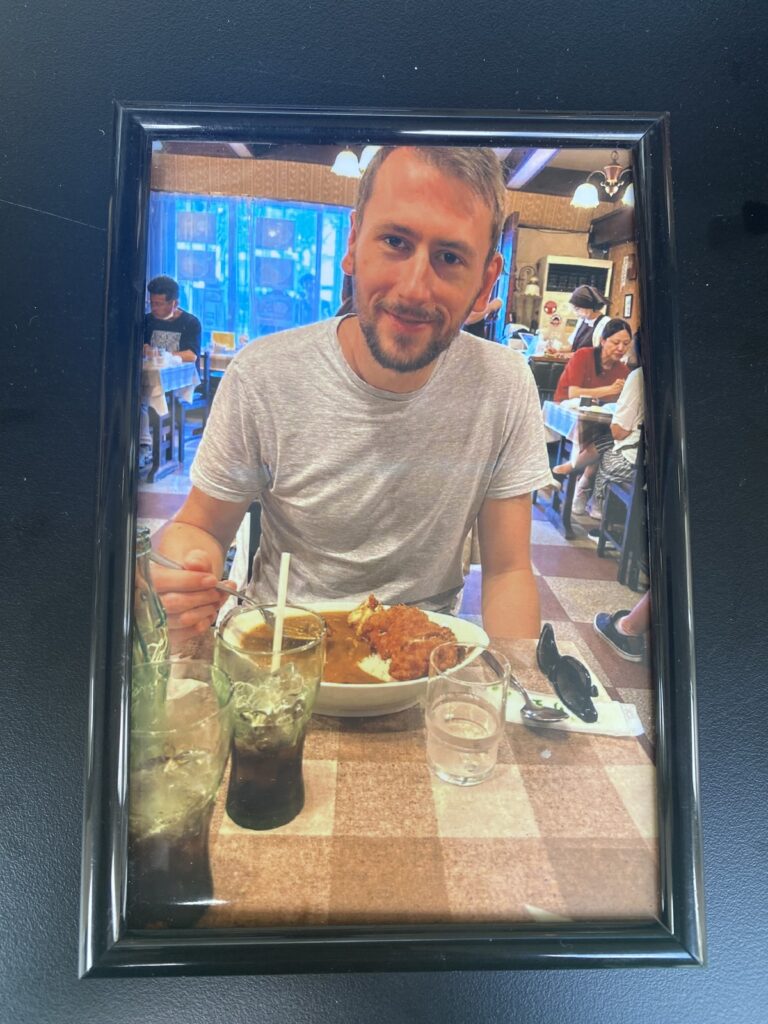 Pub staff at Boom Battle Bar in Bath were baffled by framed photos of a mystery man, dubbed "Photobooth Phil," left around the bar. The amusing social media investigation revealed it was a stag do prank.