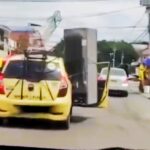 Driver in Medellín, Colombia, spotted transporting a huge fridge and rocking chair strapped to his taxi. Video of the bizarre scene goes viral amid Copa America final.