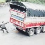 A super strong driver in Colombia appears to pull a massive truck from a muddy quagmire using just one hand, but a closer look reveals a colleague inside the cab assisting with steering and braking.