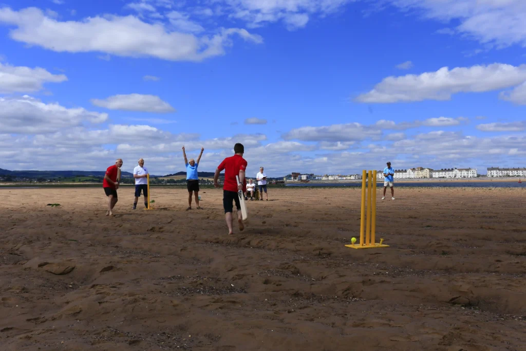 Britain's most unusual cricket match played on the River Exe estuary at low tide saw Exmouth RNLI beat Exmouth Freemasons by three runs. The unique event may become annual.