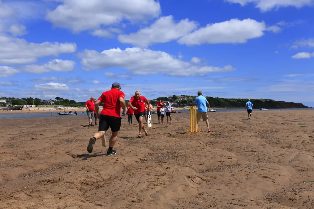 Britain's most unusual cricket match played on the River Exe estuary at low tide saw Exmouth RNLI beat Exmouth Freemasons by three runs. The unique event may become annual.