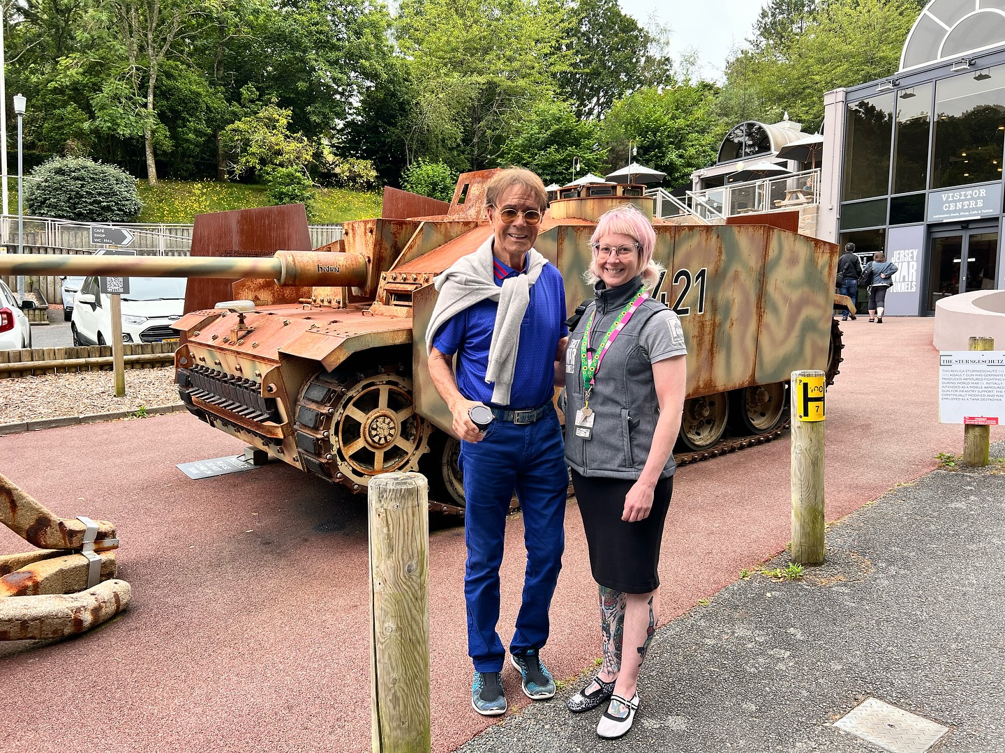 Cliff Richard, 83, enjoys a summer holiday in Jersey, visiting history museums and dining at local restaurants. Fans thrilled by his casual and charming presence.