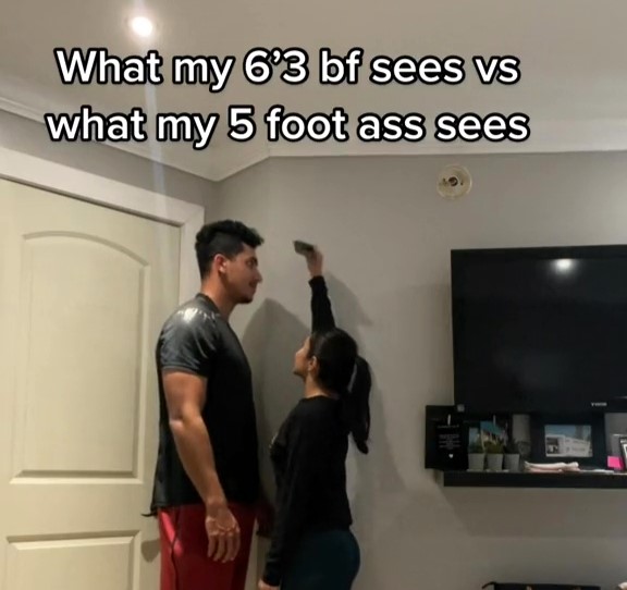 A couple's TikTok goes viral, showcasing their over a foot height difference and the unique challenges and perks in their relationship, garnering millions of views.