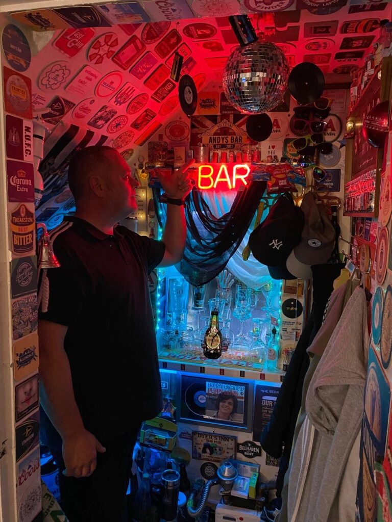 Andy Dyer, 51, transformed the cupboard under his stairs into Britain's smallest bar. With £800 spent, it's a quirky haven complete with a draft beer machine, neon sign, and disco ball.