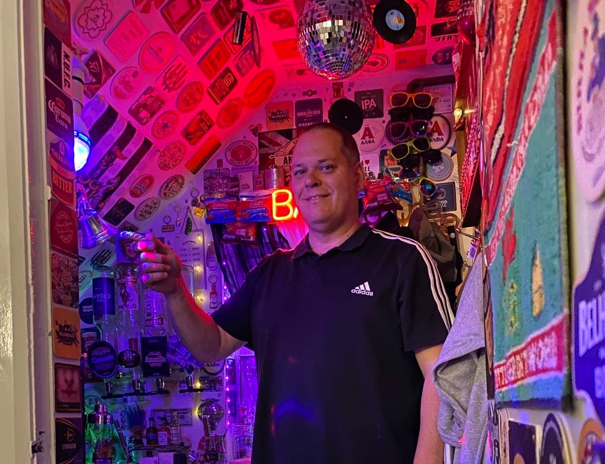 Andy Dyer, 51, transformed the cupboard under his stairs into Britain's smallest bar. With £800 spent, it's a quirky haven complete with a draft beer machine, neon sign, and disco ball.