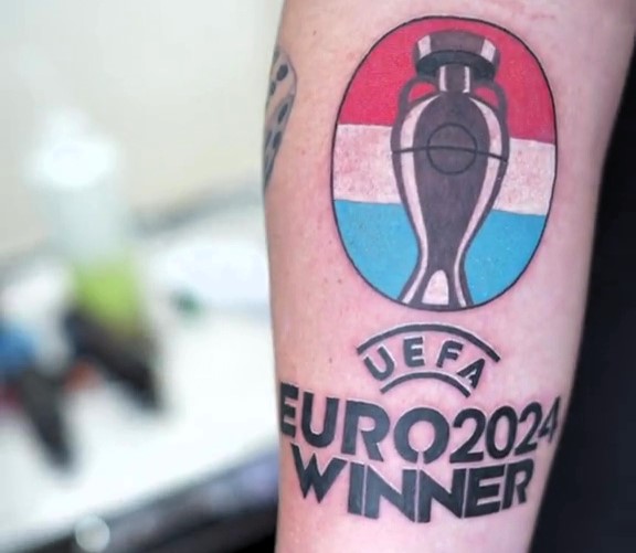 Dutch football fan Bart Blom tattoos "Uefa Euro 2024 winner" on his arm, confident of a Netherlands victory. He could win £8,400 if the Dutch team wins the championship.