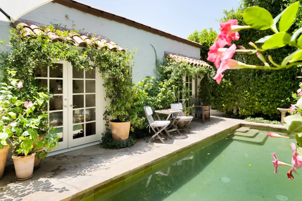 Charming West Hollywood bungalow once owned by Robert Duvall listed for $2M. Featuring Spanish-style courtyard, heated lap pool, and lush gardens. Prime location!