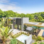 Discover Bargesi, a stunning Californian-inspired home near Newquay, Cornwall. Featuring 4 en-suite bedrooms, a natural swimming pond, and eco-friendly features. Priced at £1.85M.