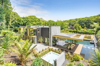 Discover Bargesi, a stunning Californian-inspired home near Newquay, Cornwall. Featuring 4 en-suite bedrooms, a natural swimming pond, and eco-friendly features. Priced at £1.85M.