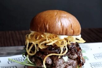 Gordon Ramsay's £18 Olympics-themed 'Frenchie Burger' receives mixed reviews. While some diners criticize its size and taste, others love its unique ingredients and flavors.