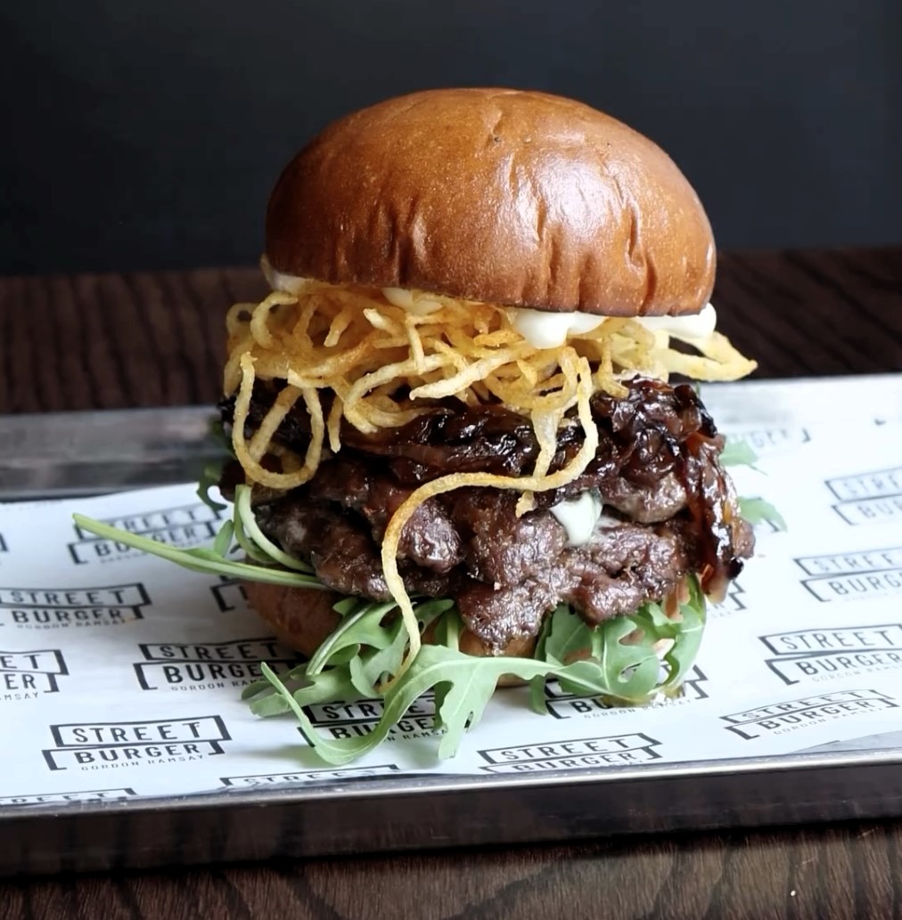 Gordon Ramsay's £18 Olympics-themed 'Frenchie Burger' receives mixed reviews. While some diners criticize its size and taste, others love its unique ingredients and flavors.