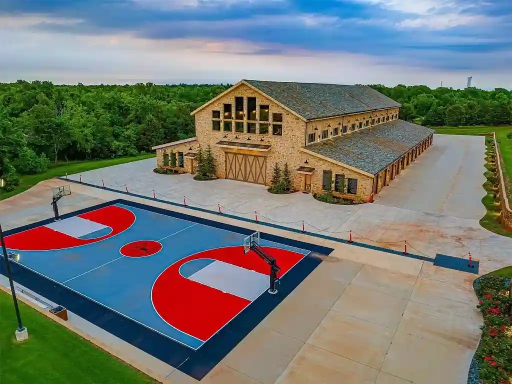 Luxurious Oklahoma City mansion for sale at $17M, featuring 8 bedrooms, 16 baths, a bowling alley, dance floor, bars, and a stunning 70,000-gallon pool. Ultimate entertainment estate.