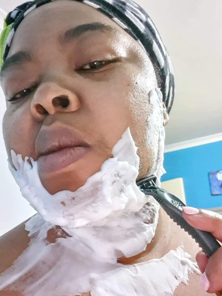 Bearded woman Khosi Nkanyezi Buthelezi shares her summer beard care routine and tips for self-acceptance, embracing her unique look with confidence despite societal reactions.