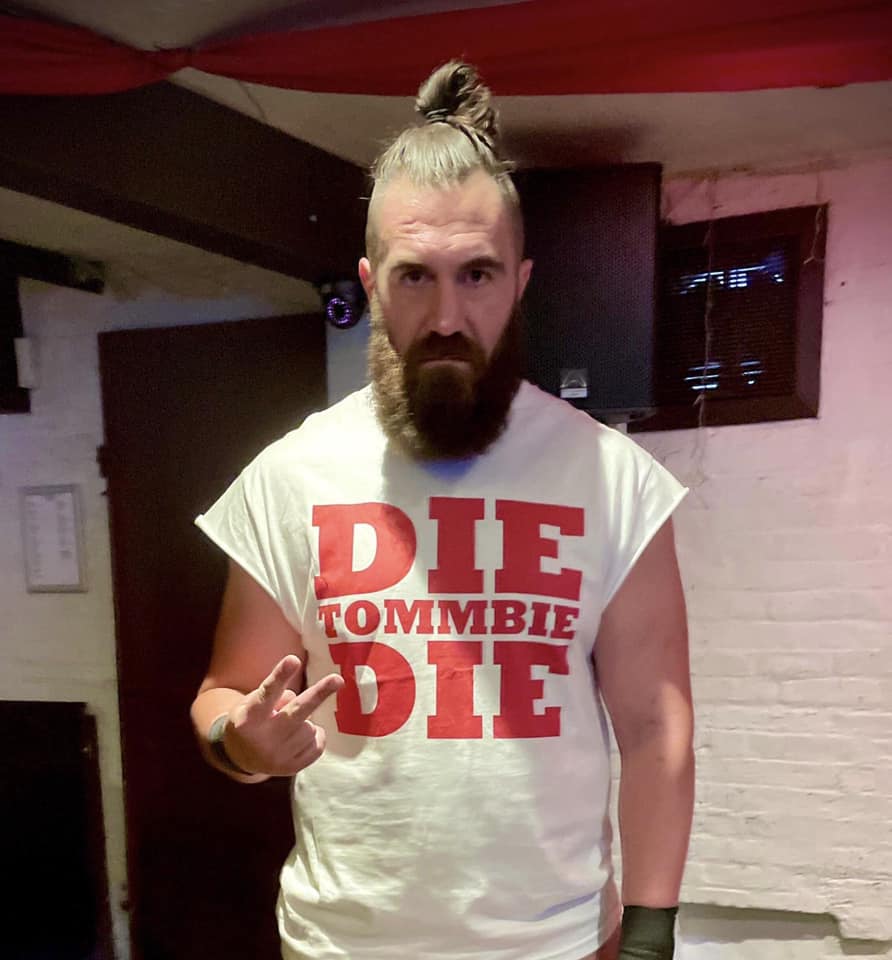 Joe Mcgivern, a store security worker by day, earns £12,000 annually from weekend death wrestling. This hardcore hobby, involving glass and blood, offers a surreal thrill and helps pay the bills.