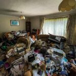 Urban explorer Sean Piper's TikTok video reveals a severely overgrown, abandoned hoarder's home in Kent, filled with damp clothes, animal droppings, and personal belongings.