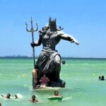 Locals blame a Poseidon statue for Hurricane Beryl, sparking plans for its demolition. The controversial figure, erected to boost tourism, is now linked to adverse weather.