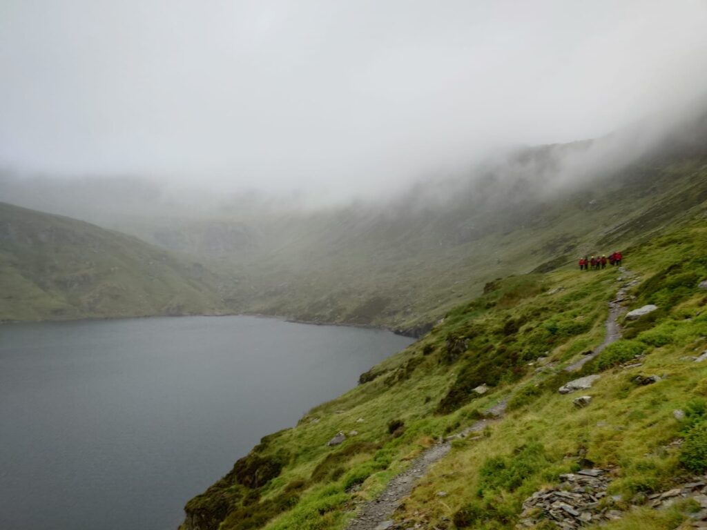 A walker on the 15 Peaks Challenge in Snowdonia was rescued with hypothermia in July. Ogwen Valley Mountain Rescue provided aid and urged hikers to check weather conditions.